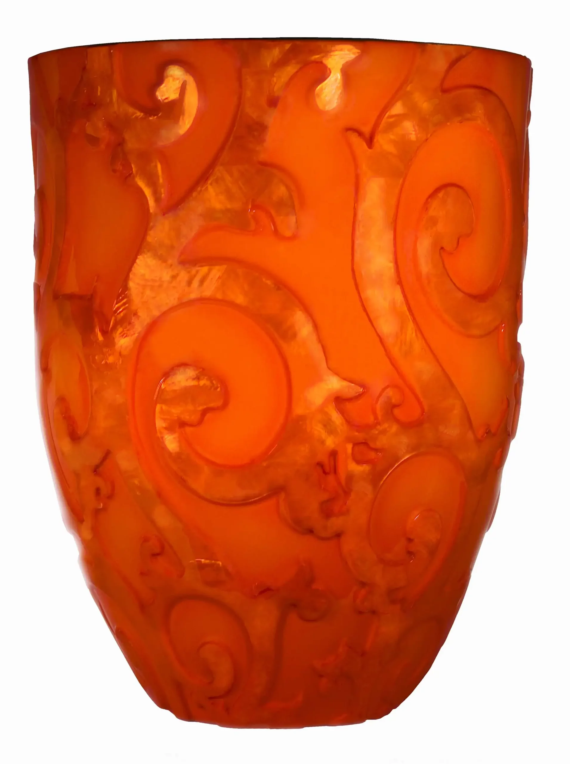 an orange vase with a swirl design