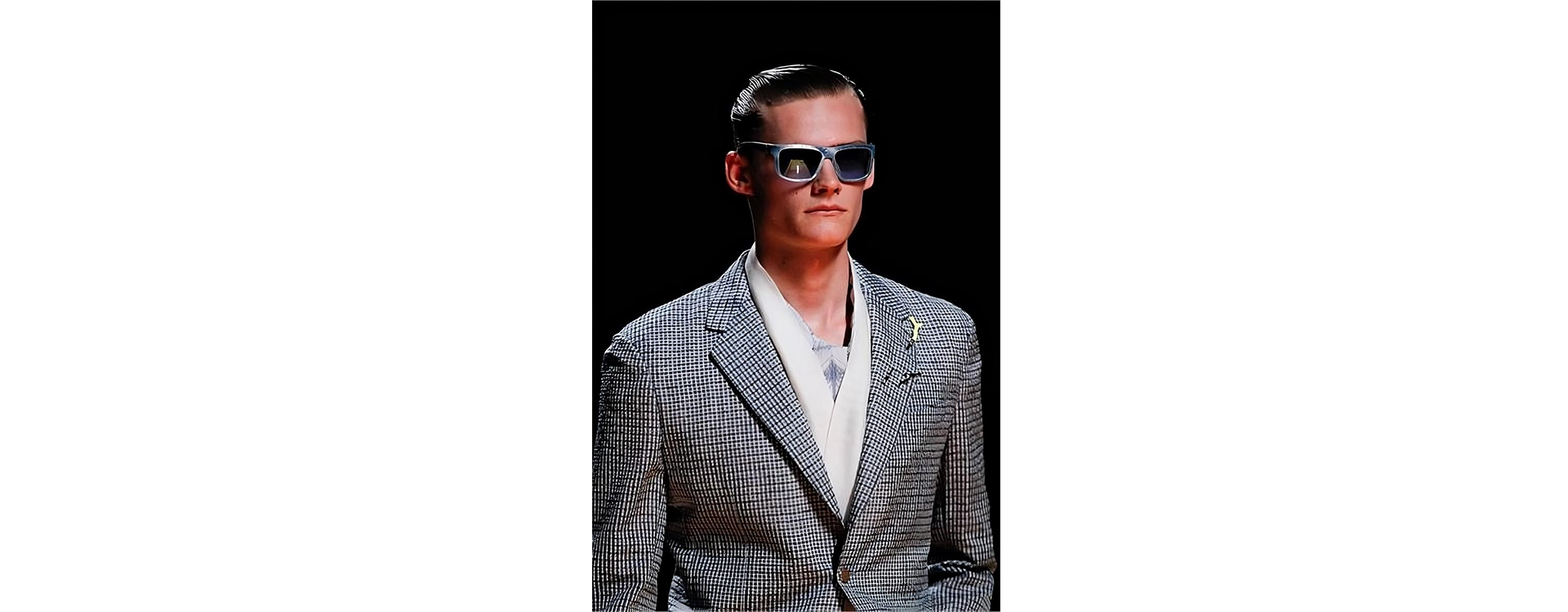 a person in a suit and sunglasses model